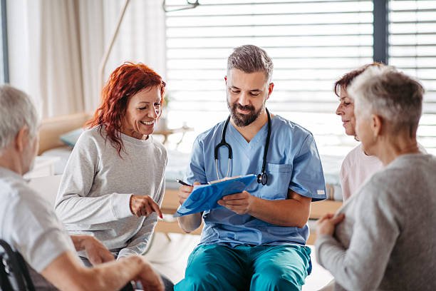 Doctor marking patients attendance on group therapy in hospital.